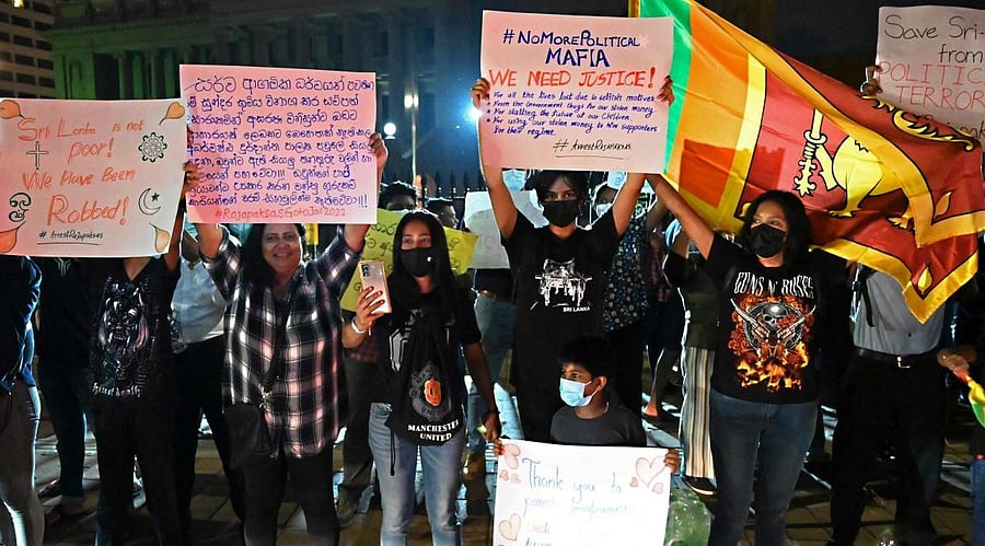 Protestors take part in a demonstration against the economic crisis at the entrance of the president's office in Colombo.