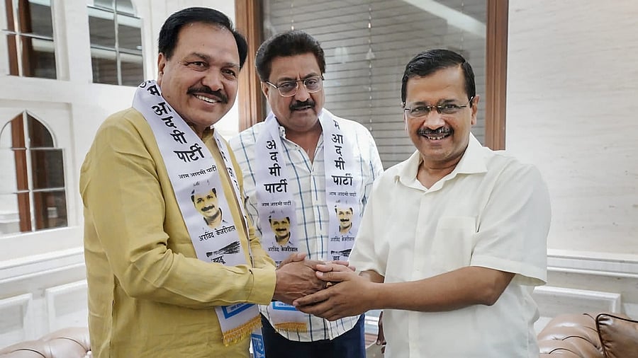 Former Congress leaders from Gujarat Indranil Rajguru and Vasrambhai Sagathi join AAP in the presence of party chief and Delhi CM Arvind Kejriwal, in Delhi. Credit: PTI Photo