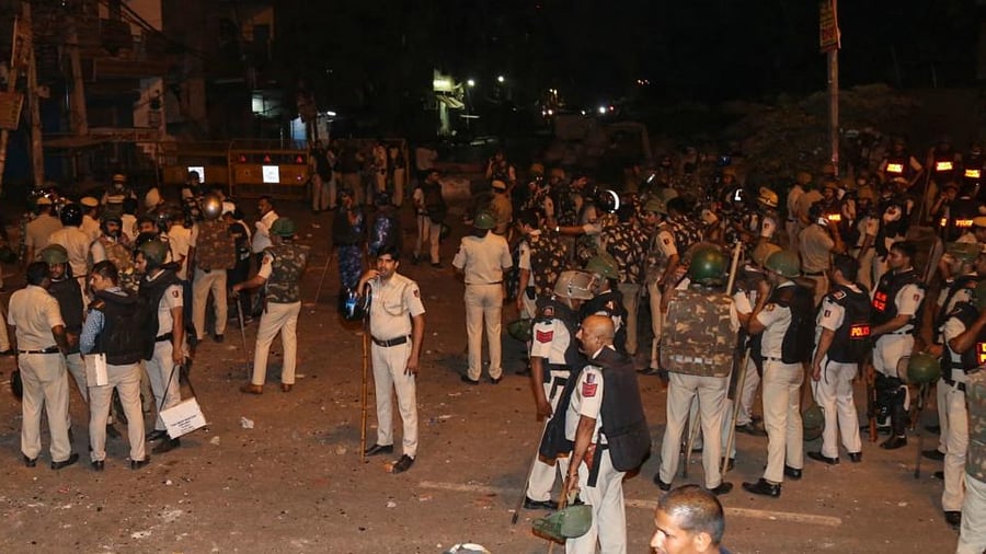 Police personnel stand guard in a residential area of Jahangirpuri, in New Delhi on April 16, 2022, after clashes between members of two communities during a 'Hanuman Jayanti' procession. Credit: AFP Photo
