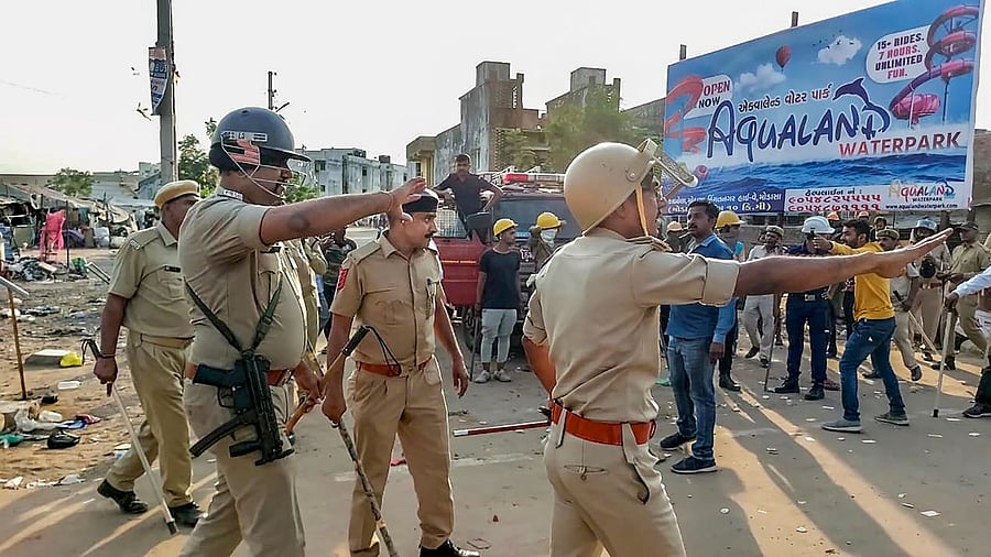 Police try to control the situation after a communal clash during the Ram Navami procession, in Himmatnagar. Credit: PTI Photo