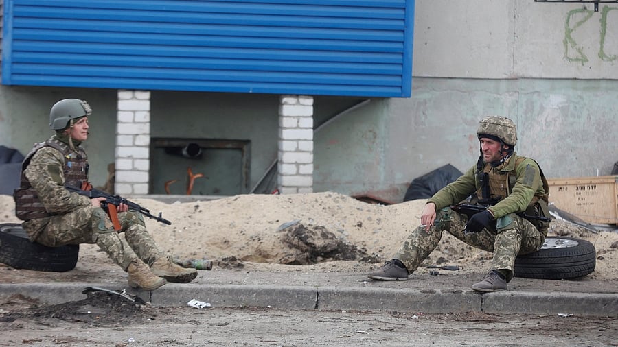 Ukrainian service members rest on a street, as Russia's attack on Ukraine continues, in Sivierodonetsk, Luhansk region, Ukraine. Credit: Reuters File Photo