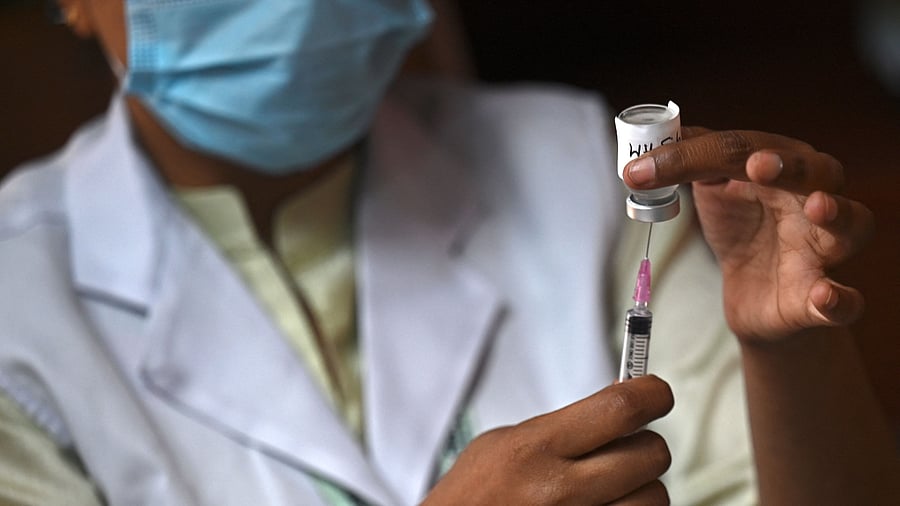 A health worker prepares to inoculate a person with a dose of the Covaxin vaccine. Credit: AFP Photo