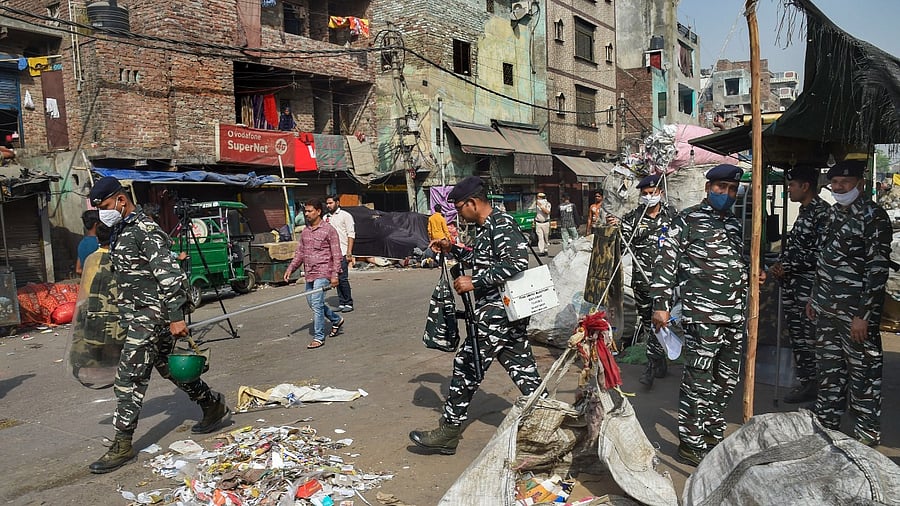 Security personnel keep vigil after clashes broke out between two communities during a Hanuman Jayanti procession on Saturday, at Jahangirpuri in New Delhi. Credit: PTI Photo