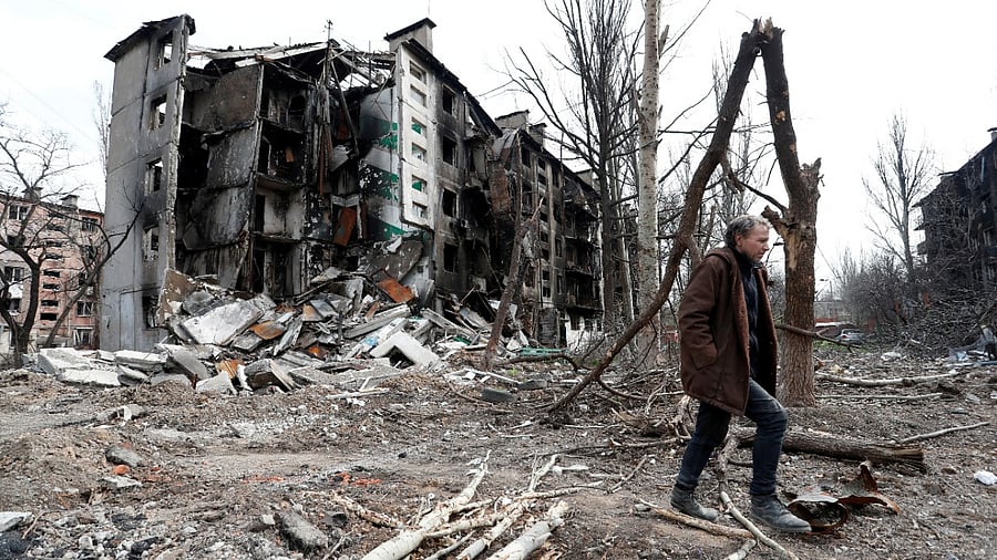 A man walks near a residential building destroyed during Ukraine-Russia conflict in the southern port city of Mariupol. Credit: Reuters Photo