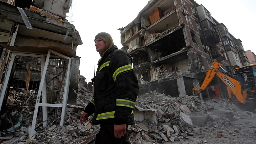 A rescuer works at a residential building damaged during Ukraine-Russia conflict in the southern port city of Mariupol. Credit: Reuters photo