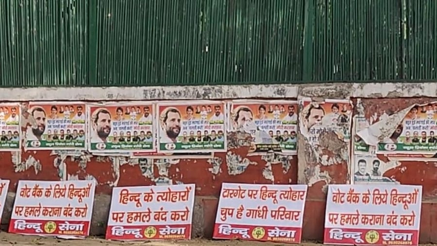 Hindu Sena activists put up posters outside Cong HQ. Credit: IANS Photo