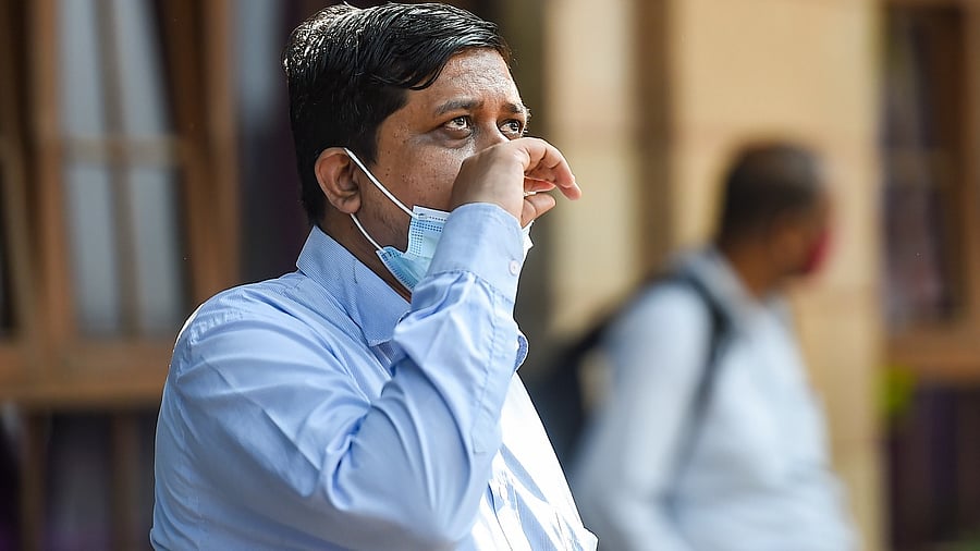 A man watches share prices on an electronic board outside the Bombay Stock Exchange (BSE), in Mumbai. Credit: PTI Photo