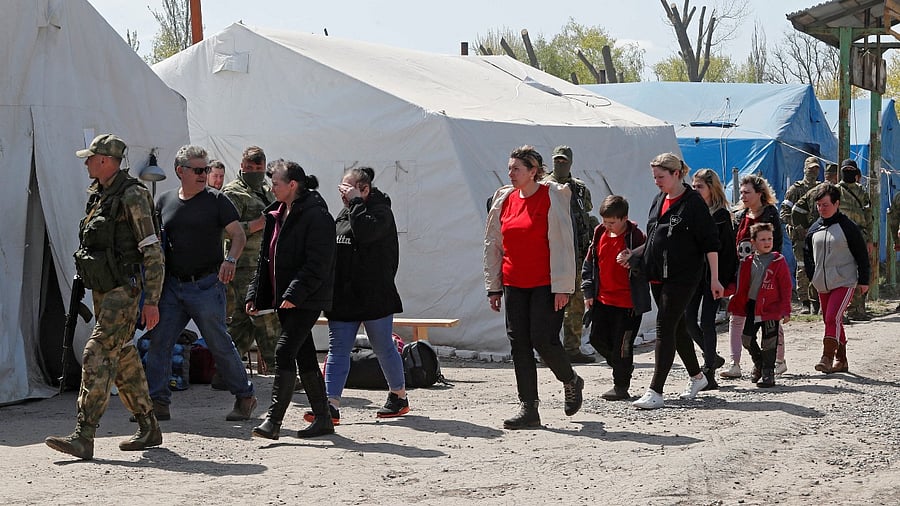 Civilians who left the area near Azovstal steel plant in Mariupol walk at a temporary accommodation centre during Ukraine-Russia conflict in the village of Bezimenne in the Donetsk Region. Credit: Reuters Photo
