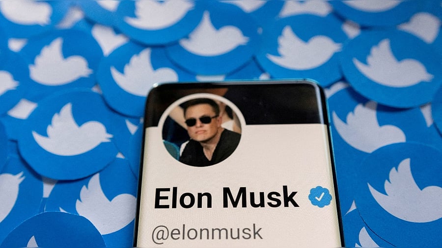 Elon Musk's Twitter profile is seen on a smartphone placed on printed Twitter logos. Credit: Reuters photo