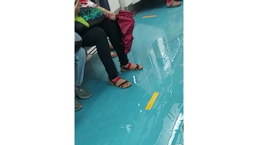 Rain water flows inside a train on Purple Line on Friday evening. Credit: DH Photo