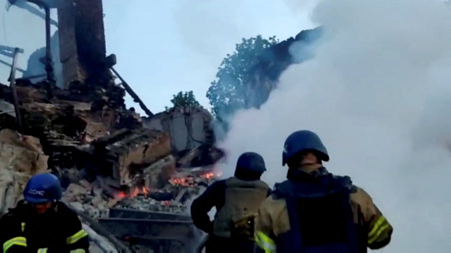 Emergency crew tend to a fire near a burning debris, after a school building was hit as a result of shelling, in the village of Bilohorivka, Luhansk, Ukraine. Credit: Reuters Photo