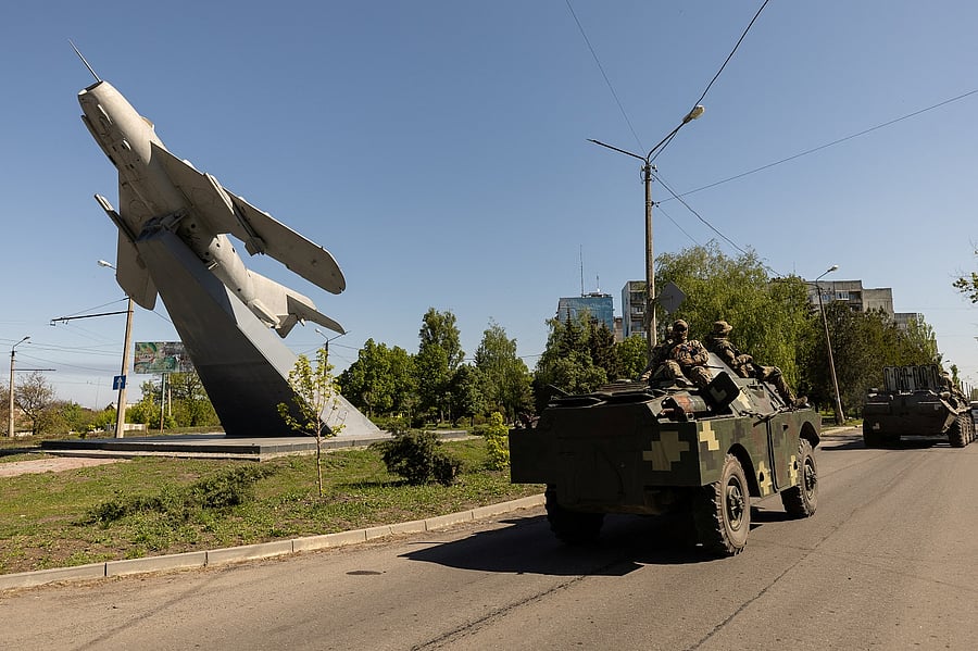 Ukrainian soldiers ride on an armored vehicle. Credit: Reuters Photo