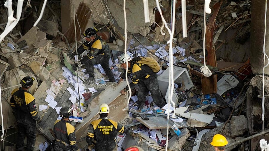 Firefighters and rescue workers remove debris from the ruins of the Saratoga Hotel, in Havana. Credit: AFP Photo