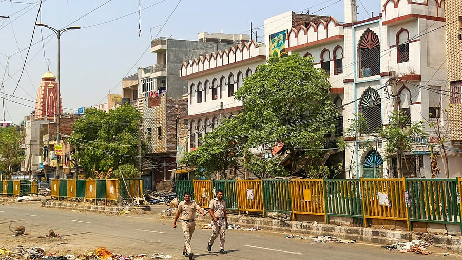 Policemen patrol in the violence-hit Jahangirpuri area. Credit: PTI Photo