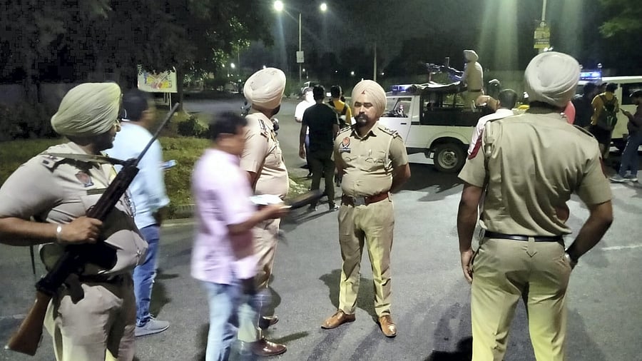Police personnel cordon off the area after a blast outside the Punjab Police's intelligence department office in Mohali. Credit: PTI Photo
