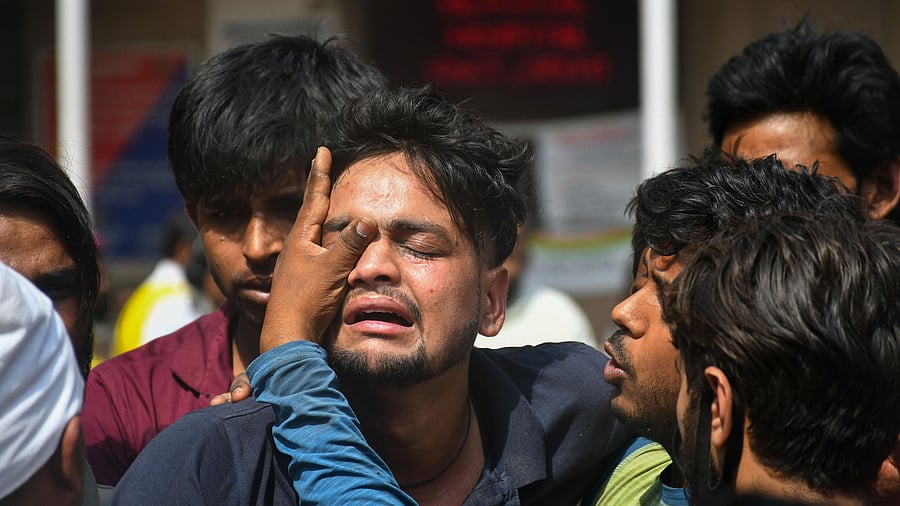 Scenes of chaos prevailed the whole night at the Sanjay Gandhi hospital where the bodies from the incident were shifted and the relatives of the missing persons kept arriving to locate their loved ones. Credit: PTI Photo