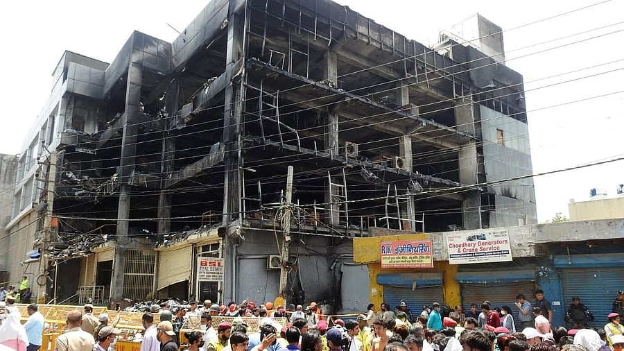 Rescuers working at the incident site after a massive fire breaks out at an office building near the Mundka Metro Station. Credit: IANS photo