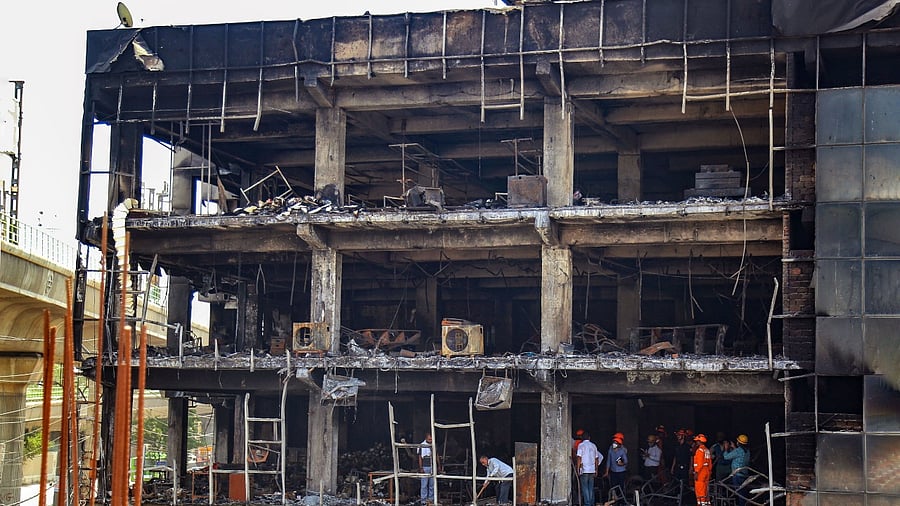 Officials investigate the Mundka fire, in New Delhi. Credit: PTI Photo