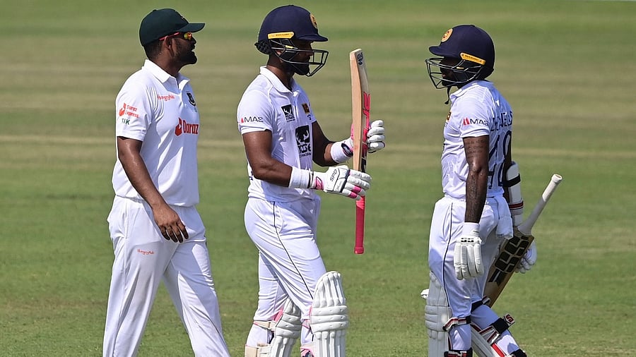 Bangladesh's Tamim Iqbal (L) talks with Sri Lanka's Dinesh Chandimal (C) and Niroshan Dickwella (R) during the final day of the first Test at the Zahur Ahmed Chowdhury Stadium in Chittagong. Credit: AFP Photo