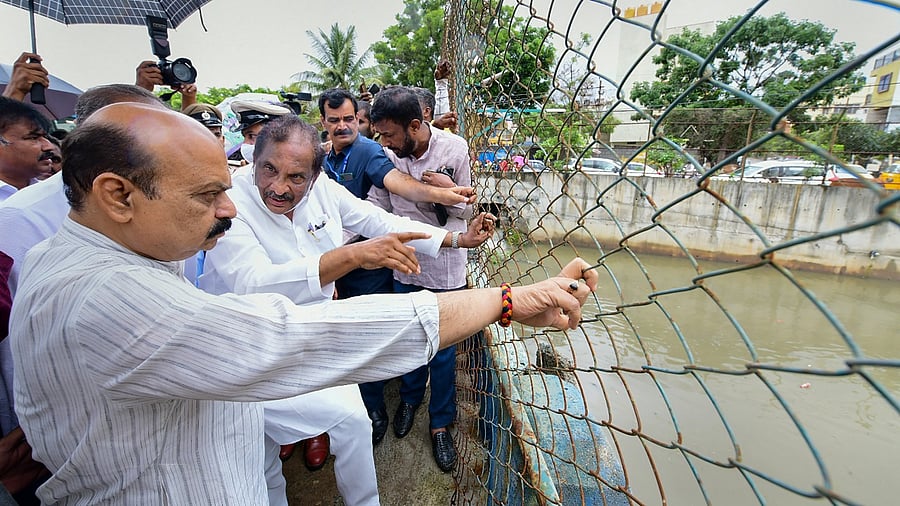 Karnataka Chief Minister Basavaraja Bommai inspects a flooded area following heavy downpour, in Bengaluru. Credit: PTI Photo