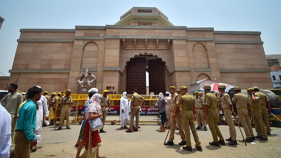 Policemen stand guard as Muslim devotees arrive to offer Friday noon prayer at the Gyanvapi mosque in Varanasi. Credit: AFP Photo