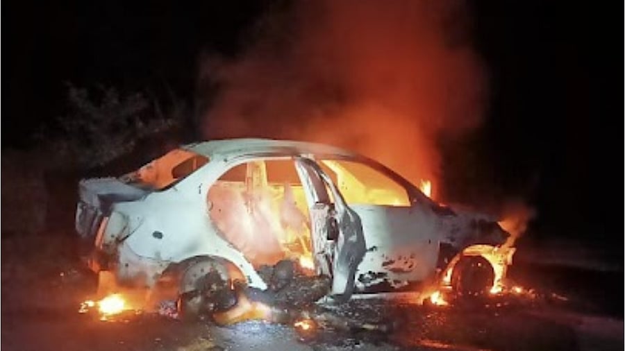 The car that was on ablaze at Heggunje in Udupi. Credit: Special Arrangement