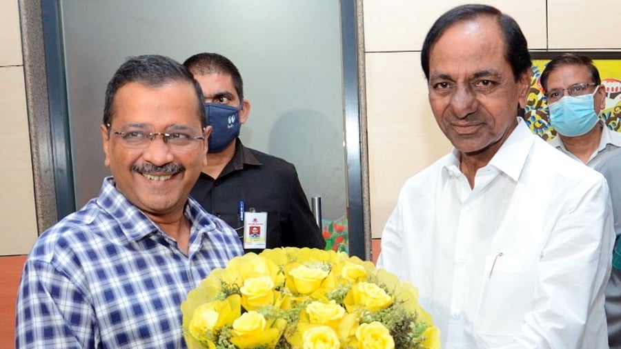 Delhi Chief Minister Arvind Kejriwal presents a bouquet to Telangana Chief Minister K. Chandrashekar Rao. Credit: PTI Photo