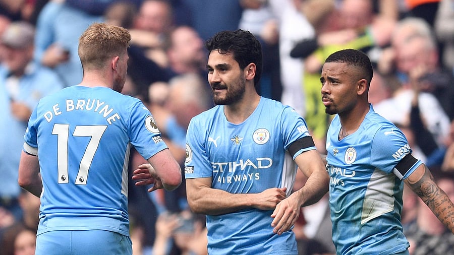 Manchester City's German midfielder Ilkay Gundogan (C) celebrates with teammates after scoring his team third goal during the English Premier League football match between Manchester City and Aston Villa. Credit: AFP Photo