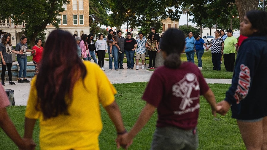 Members of the community gather at the City of Uvalde Town Square for a prayer vigil in the wake of a mass shooting at Robb Elementary School. Credit: AFP Photo
