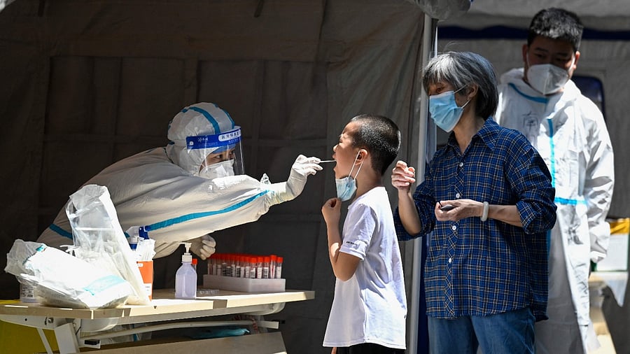 Beijing health authorities have been sending out text messages to people's mobile phones urging them to monitor the travel histories of Covid-19 cases and report themselves to local officials if their own movements overlap with those of the infected. Credit: AFP Photo