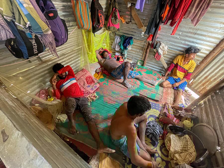 The injured workers in their shed. Credit: DH Photo/Pushkar V