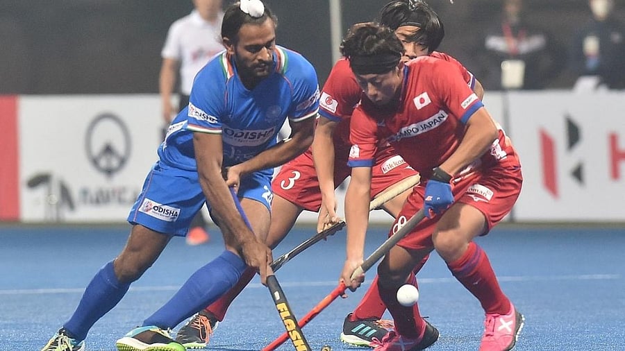 Japan's Taiki Takade (R), with teammate Takuma Niwa (C) fight for the ball against India's Jaskaran Singh during the men's field hockey semi final. Credit: AFP Photo