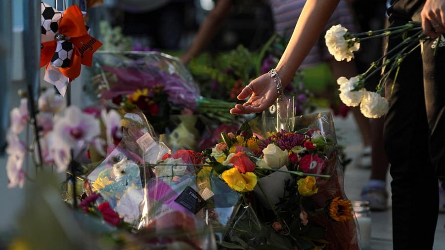 People put flowers on memorial crosses for the children victims of the mass shooting at Robb Elementary School, in front the Uvalde County Courthouse in Uvalde. Credit: Reuters photo