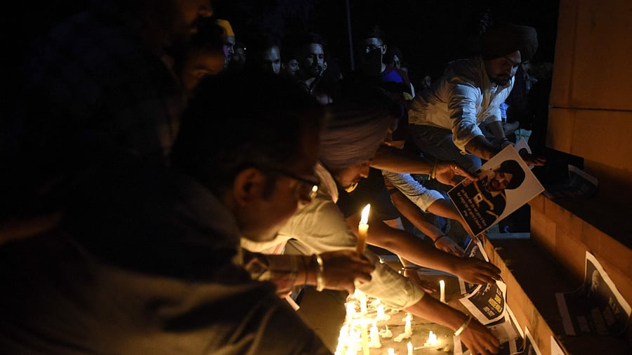 Youths pay tribute during a candlelight vigil for the late Indian rapper Sidhu Moose Wala, whose real name is Shubhdeep Singh Sidhu. Credit: PTI Photo
