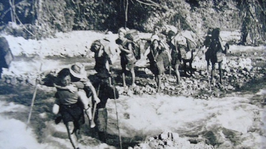 Local people helping visitors to cross the river by carrying them on their back during 1950 Assam earthquake. Credit: Wikimedia Commons