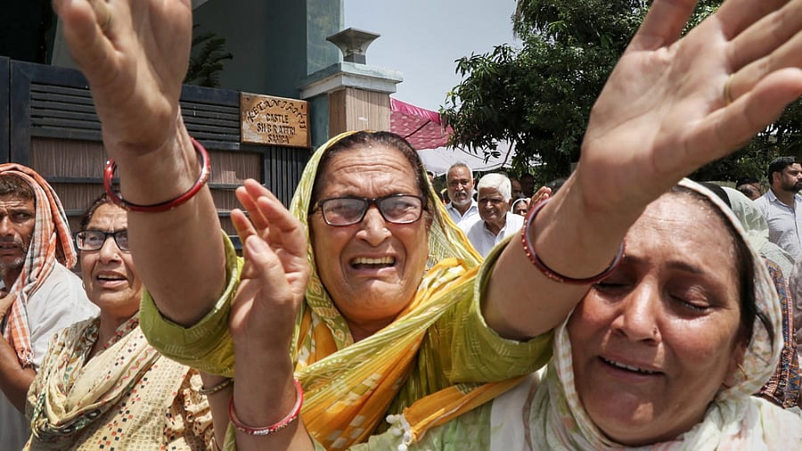 Relatives and family members of government teacher Rajni Bala mourn during her funeral, in Samba, Wednesday, June 1, 2022. Credit: PTI Photo