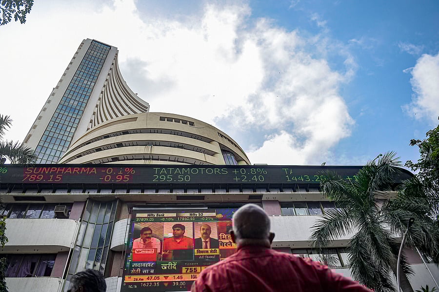 A man reacts as he watches share prices on a digital screen outside the Bombay Stock Exchange (BSE) in Mumbai. Credit: PTI Photo