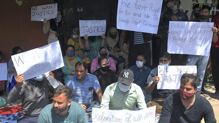 Kashmiri pandit employees hold placards during a protest demanding justice over the killing of Rahul Bhat in Srinagar. Credit: PTI Photo