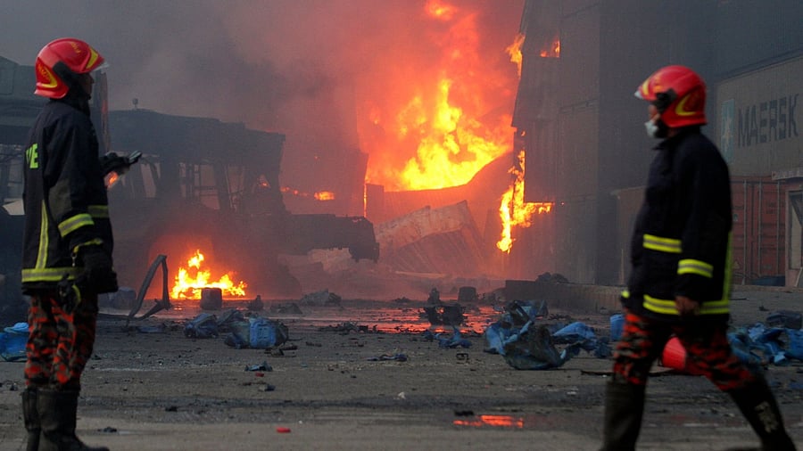 Firefighters arrive at the site after a fire broke out at a container storage facility in Sitakunda. Credit: AFP Photo