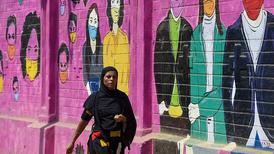 mural depicting people wearing facemasks to create to awareness about the Covid-19 in Mumbai. Credit: AFP Photo
