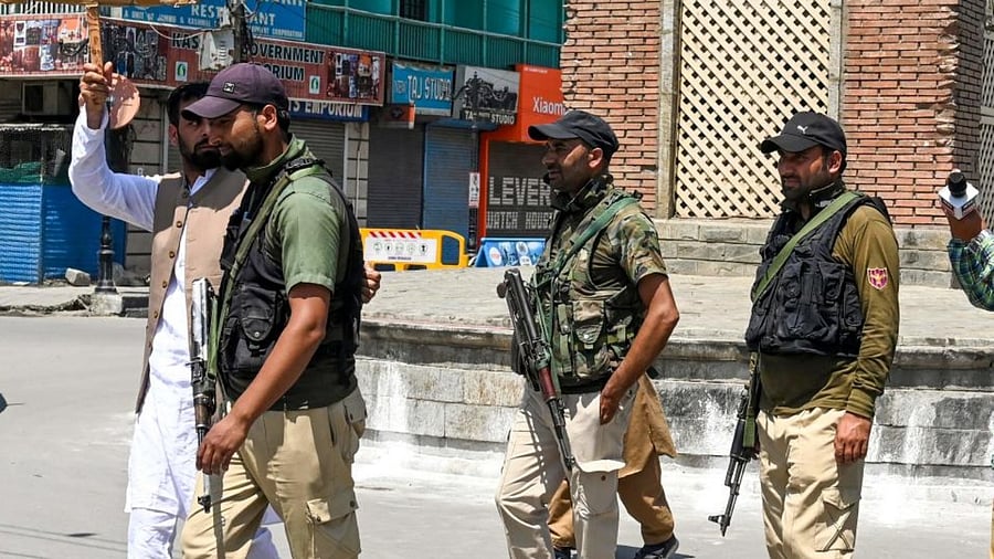 Policemen detain a man during a protest in Srinagar on June 10, 2022. Credit: AFP Photo