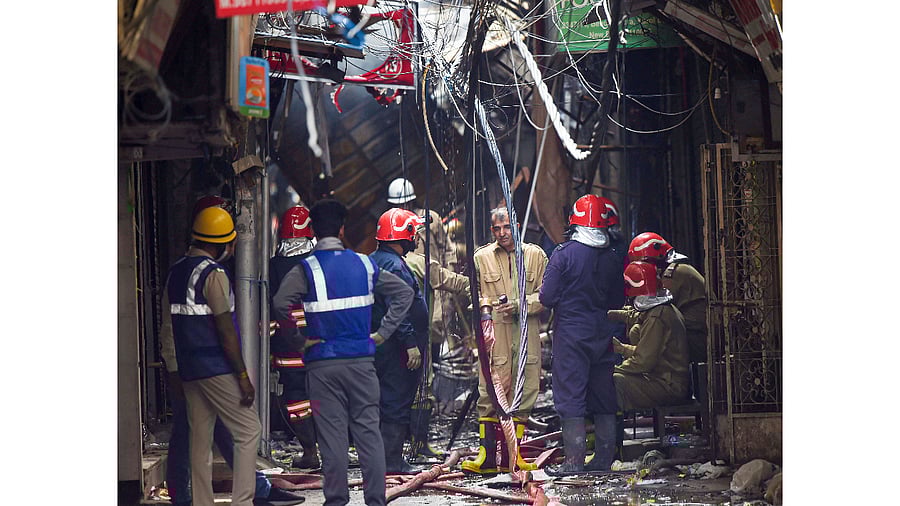 Firefighters at the site after fire broke out at Gaffar market, at Karol Bagh in New Delhi. Credit: PTI Photo