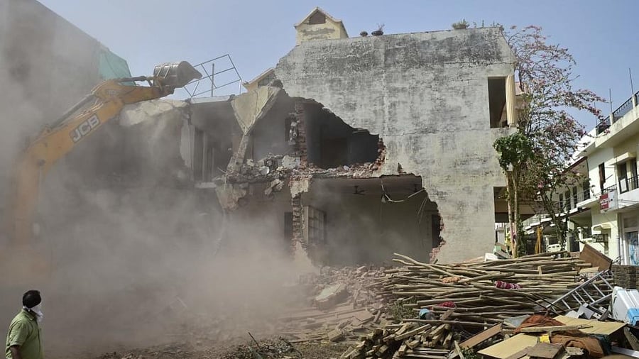 A bulldozer is being used to demolish the illegal structures of the residence of Javed Ahmed, a local leader who was allegedly involved in the recent violent protests against Bharatiya Janata Party (BJP) former spokeswoman Nupur Sharma's incendiary remarks about Prophet Mohammed, in Allahabad on June 12, 2022. Credit: AFP Photo