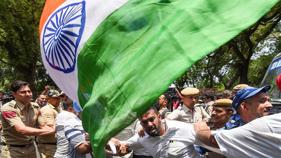 Congress workers protest outside the AICC office against summoning of party leader Rahul Gandhi by the Enforcement Directorate (ED) in connection with the National Herald case, in New Delhi. Credit: PTI Photo
