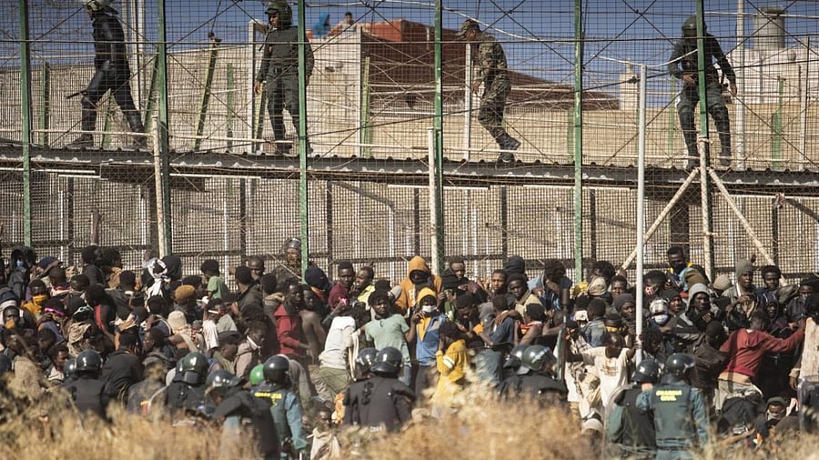 Riot police officers cordon off the area after migrants arrive on Spanish soil and crossing the fences separating the Spanish enclave of Melilla from Morocco in Melilla, Spain. Credit: AP/PTI Photo