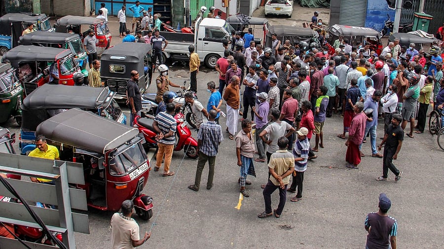 People block a road as they protest against scarcity of fuel near a fuel station in Colombo. Credit: AFP Photo