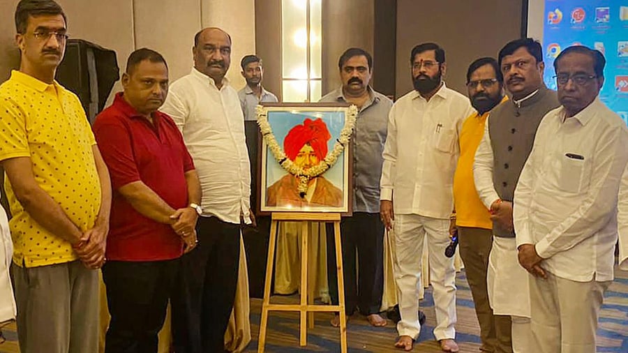 Rebel Shiv Sena leader Eknath Shinde with supporting Maharashtrian MLAs after paying tribute to Rajarshi Chhatrapati Shahu Maharaj, on the occasion of his birth anniversary, in Guwahati. Credit: PTI Photo