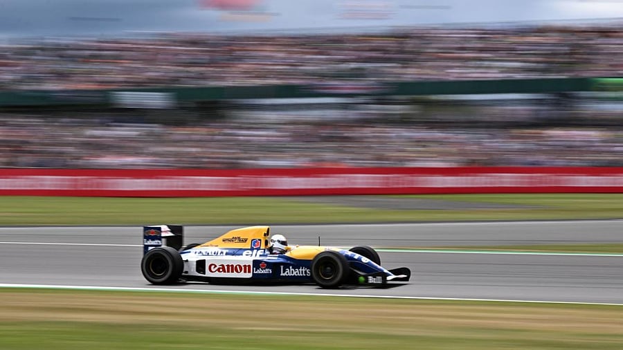 Aston Martin's German driver Sebastian Vettel drives a 1992 Williams FW14B grand prix car, used by British driver Nigel Mansell in 1992. Credit: AFP Photo