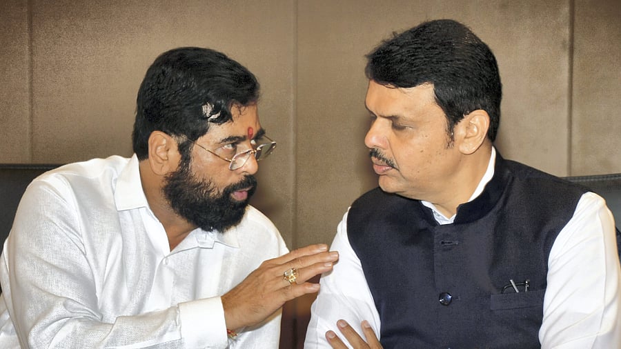 Maharashtra CM Eknath Shinde talks with Deputy Chief Minister Devendra Fadnavis. Credit: PTI Photo