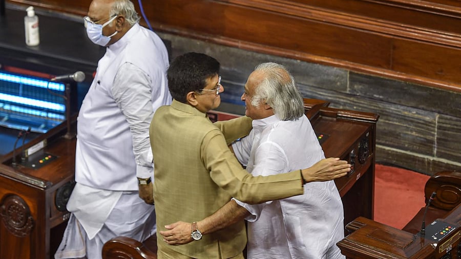 Union Minister Piyush Goyal and Congress leader Jairam Ramesh hug after taking oath as Rajya Sabha members at Parliament House. Credit: PTI Photo